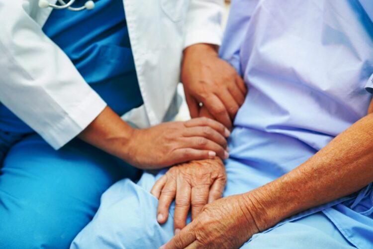 Doctor taking care, help and encourage Asian elder senior woman patient in clinic hospital.